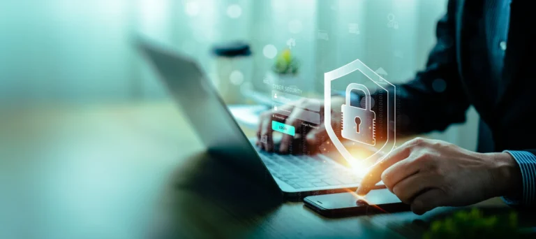 Laptop and smartphone with a cybersecurity shield representing data protection